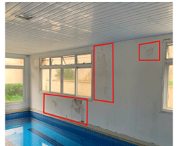 Indoor heated pool room with visible water damage and mold growth on the walls